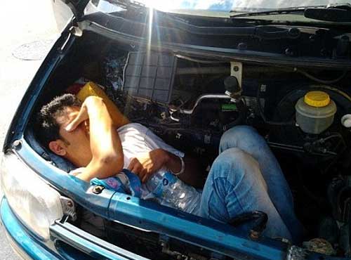 Illegal immigrant hides under cars bonnets