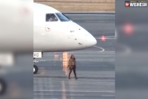 women Canberra Airport (CBR), Qantaslink Embraer, women run to the plane on the tarmac, Security breach