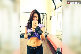 Shriya Saran lifts shirt to show navel