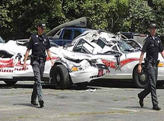 Man crushes police cruisers with tractor